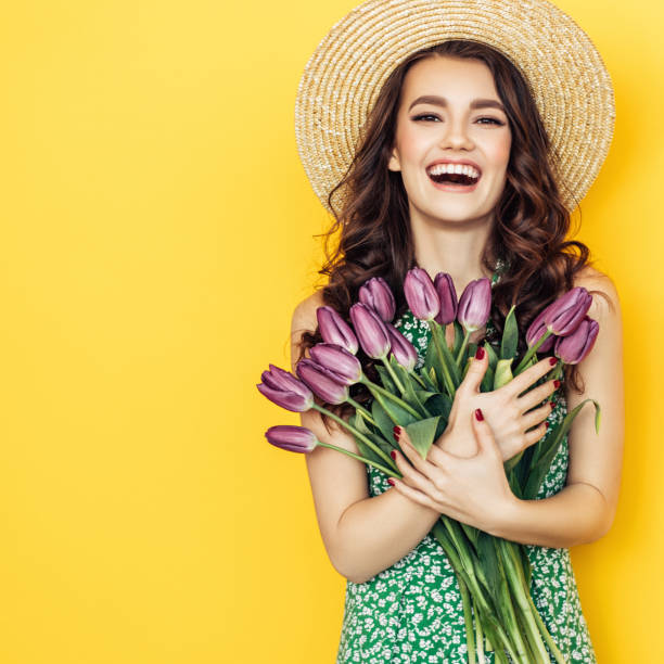 istock Lovely woman with purple tulips bunch 1127367499