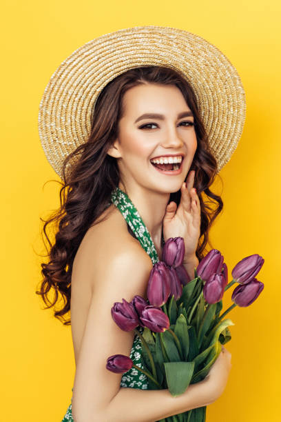 istock Lovely woman with purple tulips bunch 1127367670