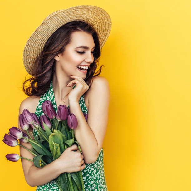 istock Lovely woman with purple tulips bunch 1127367733