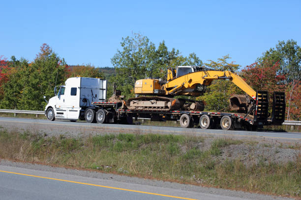 istock Semi-truck on a highway with an excavator 1127372594