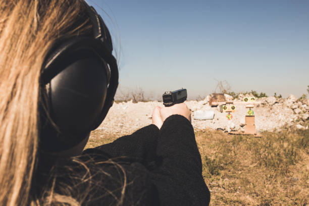 istock Woman shooting with a gun 1127373433