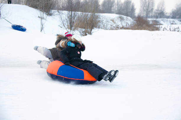 istock Child sledding tubing. 1127373698