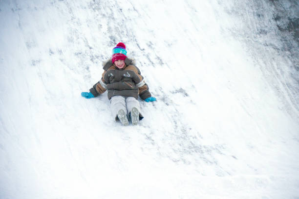 istock The boy drives off a snow slide 1127373736