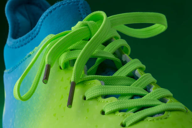 istock Green blue sneakers on a green background 1127373762