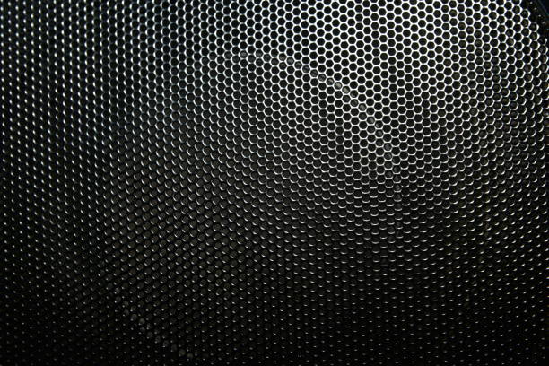 istock The speaker of a musical column hidden behind a grid with a pattern of rhythmically arranged holes 1127374609