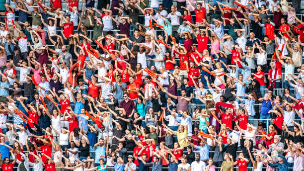 istock Crowd cheering for their team with arms raised 1127374653