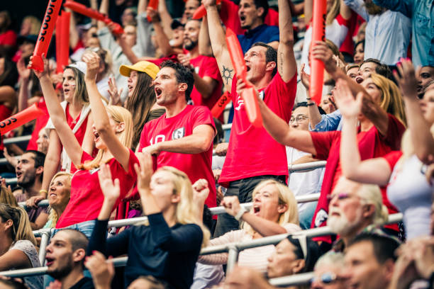 istock Crowd cheering for their team with arms raised 1127374656