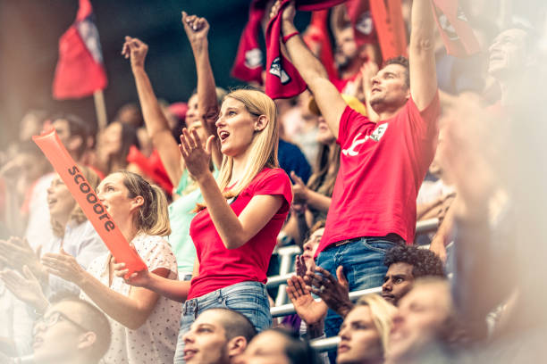 istock Crowd cheering for their team with arms raised 1127374661