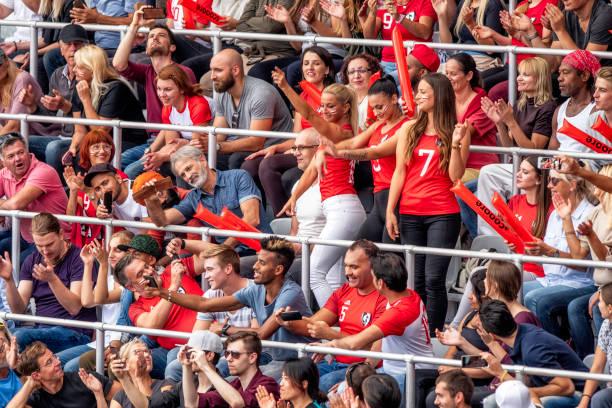 istock Three beautiful women cheering in a stadium crowd 1127374673