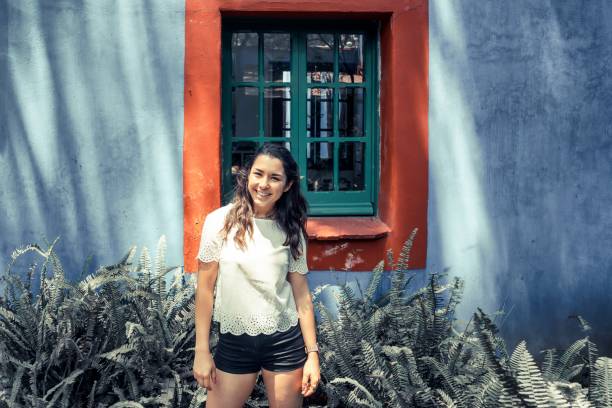 istock Beautiful young woman with rustic background 1127375125