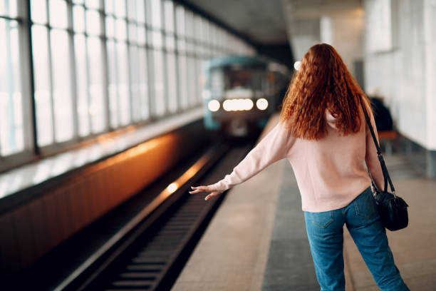 istock Positive redhead young female stops subway train 1127375390