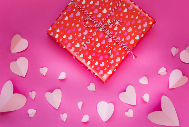 istock Gift box on pink background with heart shape 1127376248