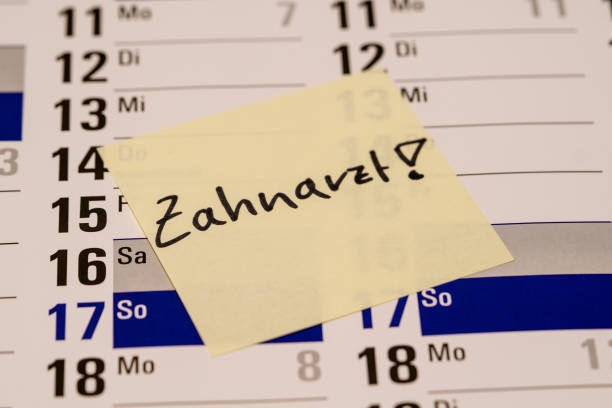 istock Dentist appointment on note on the calendar in German 1127377292