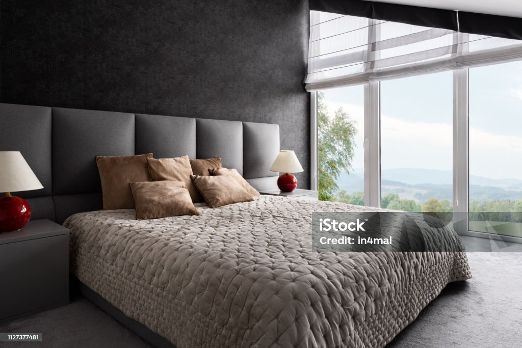 Fancy bedroom with window wall Fancy bedroom with king size bed and window wall Bedroom Stock Photo