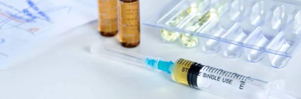 istock Medical syringe with injection solution, medicine pills and capsules on white background. Healthy medical concept 1127377880