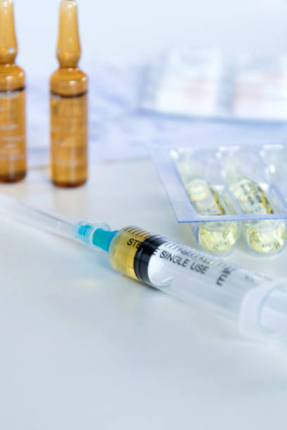 istock Medical syringe with injection solution, medicine pills and capsules on white background. Healthy medical concept 1127377884