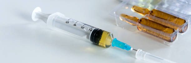 istock Medical syringe with injection solution, medicine pills and capsules on white background. Healthy medical concept 1127377895