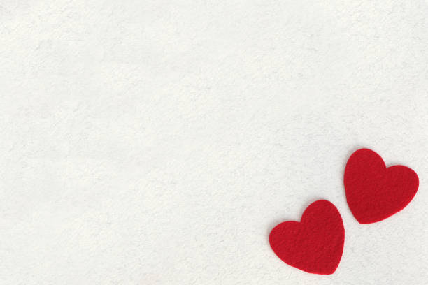 istock red felt hearts on white paper background with space for text 1127377966