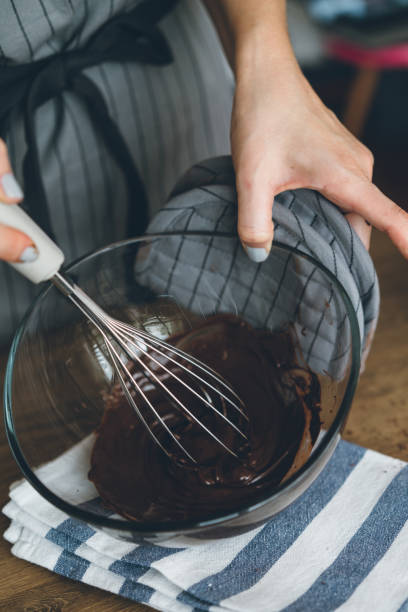 istock Young woman mixing the chocolate bowl 1127378869