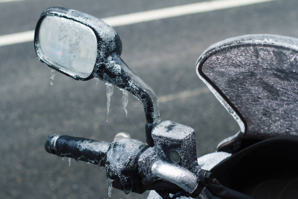 closeup of frozen motorcycle windshield and rear mirror stock photo