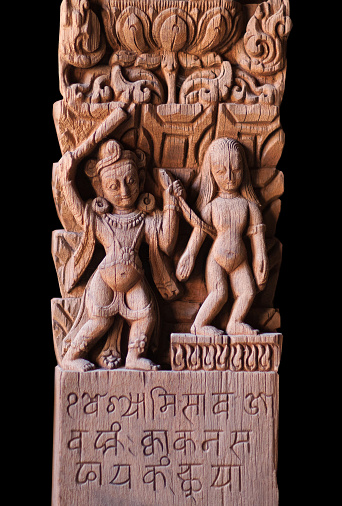 Ancient Nepalese wooden carving at the column in palace on Durbar square in Patan, Kathmandu valley, Nepal