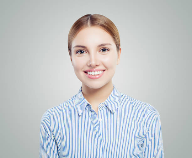 istock Happy young woman student smiling on white background 1127381892