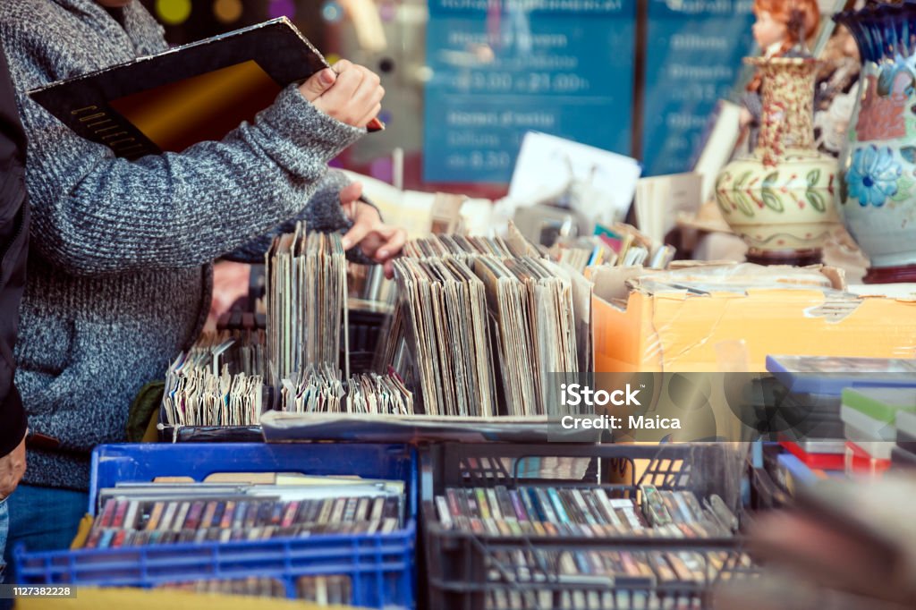 Old vinyl discs flea market Customer browsing vybyl discs at a vintage flea market. Thrift Store Stock Photo