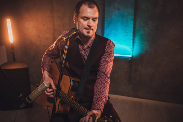 istock Musician singing and playing acoustic guitar 1127382507