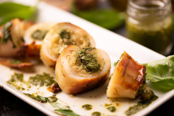 Grilled squid stuffed with basil closeup. stock photo