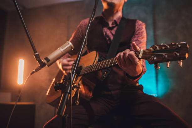istock Musician singing and playing acoustic guitar 1127383907