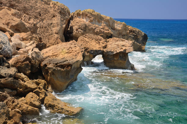 istock waves hitting against the stony coast, in the summer hot afternoon 1127384493