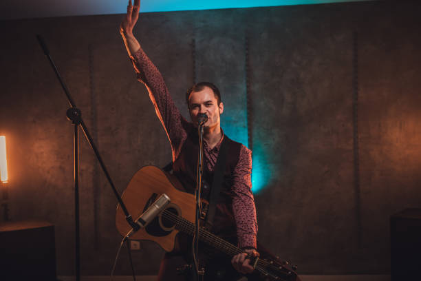 istock Musician singing and playing guitar 1127384499