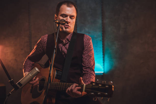 istock Musician singing and playing acoustic guitar 1127384878