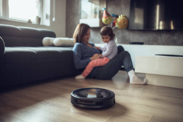 istock Robotic Vacuum Cleaner Cleaning While Mother and Daughter Playing 1127387538