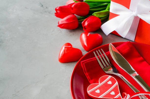 istock Festive table setting for Valentine's Day with gift box and tulips. 1127392342