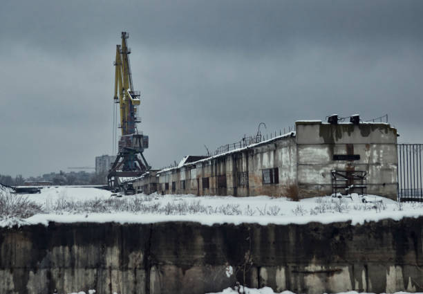 Old industrial zone, crushed buildings in the river port Old industrial zone, crushed buildings in the river port barbed wire wire factory sky stock pictures, royalty-free photos & images