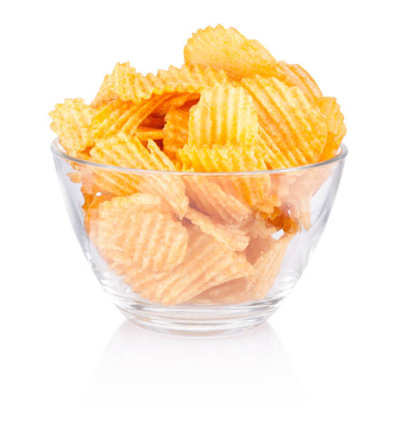 istock Crinkle cut potato chips in bowl isolated on a white background 1127394013