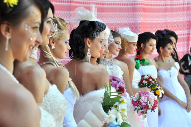 Fashion models with beautiful makeup in bride style standing in the brides parade ( traditional show) - May 26, 2012 Cherkasy, Ukraine