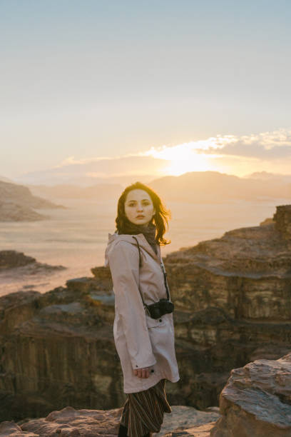 istock Woman looking at  Wadi Rum desert from rock 1127396591