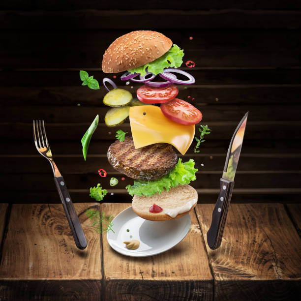 istock Hamburger ingredients falling down one by one to create a perfect meal. 1127396623