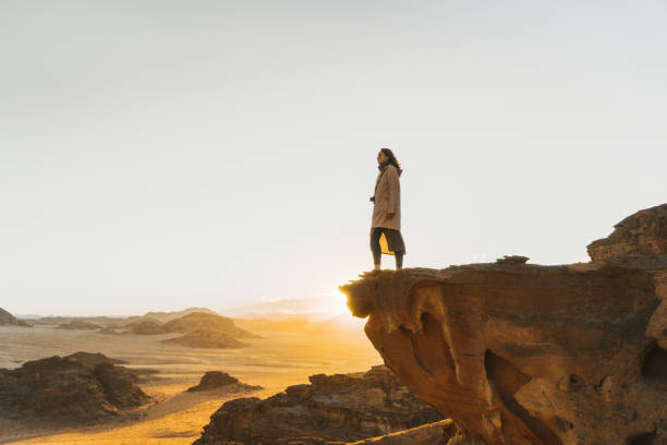 istock Woman looking at  Wadi Rum desert from rock 1127396671