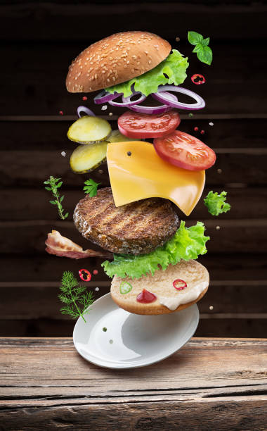 istock Hamburger ingredients falling down one by one to create a perfect meal. 1127396695
