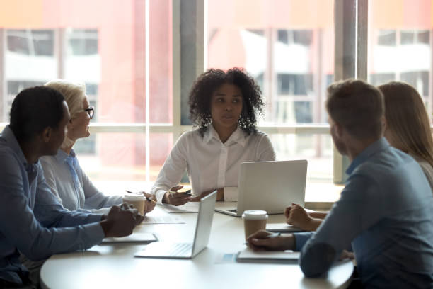 istock Five diverse business people negotiating at modern boardroom 1127397311