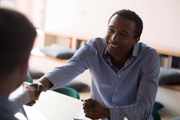 istock Black confident businessman handshaking with business partner 1127397378