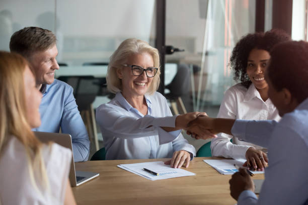 istock Happy partners shaking hands finish meeting successfully 1127397384
