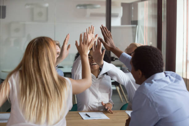 istock Like minded diverse teammates giving high five celebrating success 1127397399