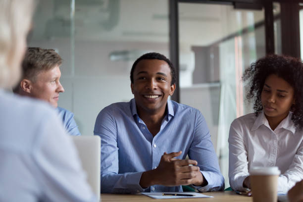 istock Diverse businesswomen and businessmen communicating while sitting in conference 1127397406