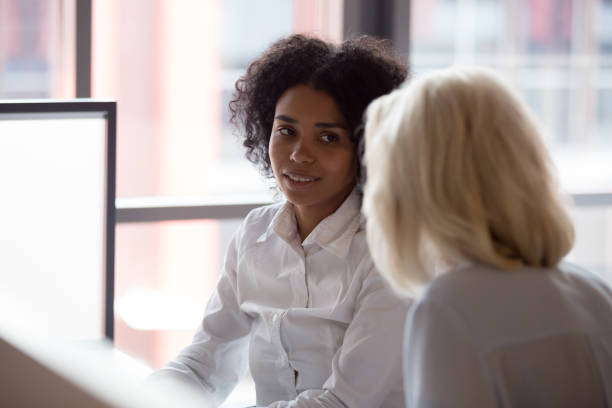 istock Diverse people negotiating in office, focus on black female 1127397434