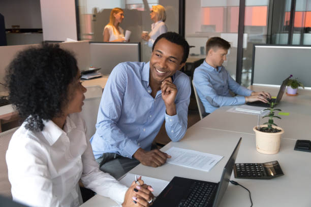 istock Afro woman and black man colleagues communicating during working day 1127397447