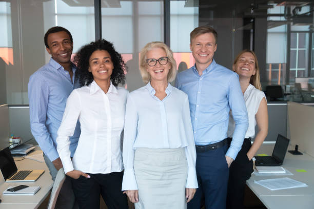 istock Diverse colleagues led by company chief posing for camera 1127397489